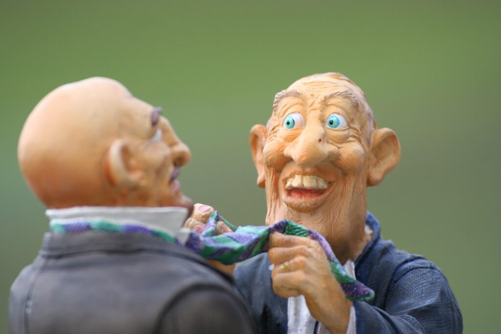 Two caricature figures engaged in an animated conversation, one playfully holding the other's tie.