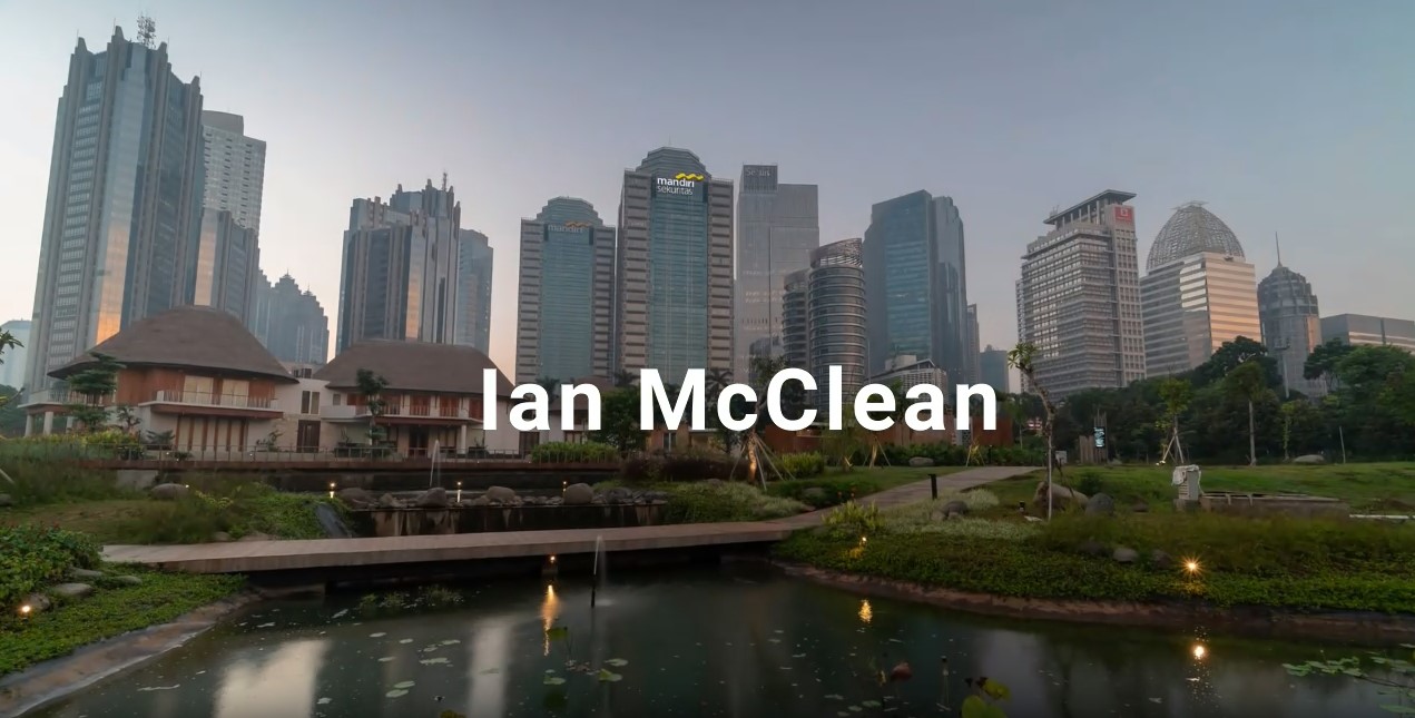 Skyscrapers in a cityscape with a serene park and pond in the foreground, showcasing urban and natural harmony at dusk.